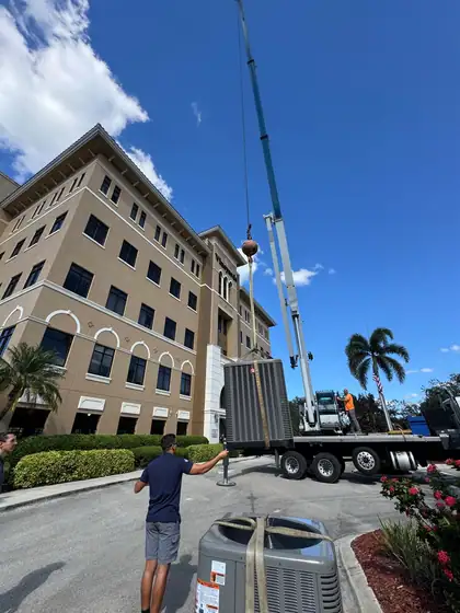 Rooftop unit on the crane, ready to set