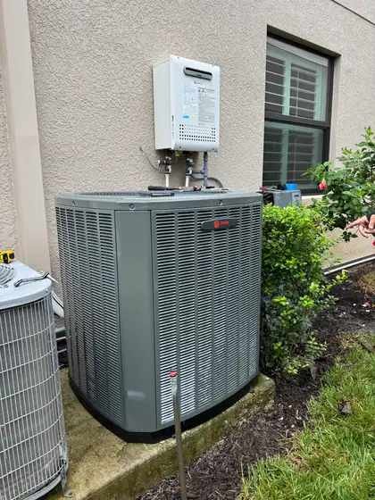New condenser installed beside a home
