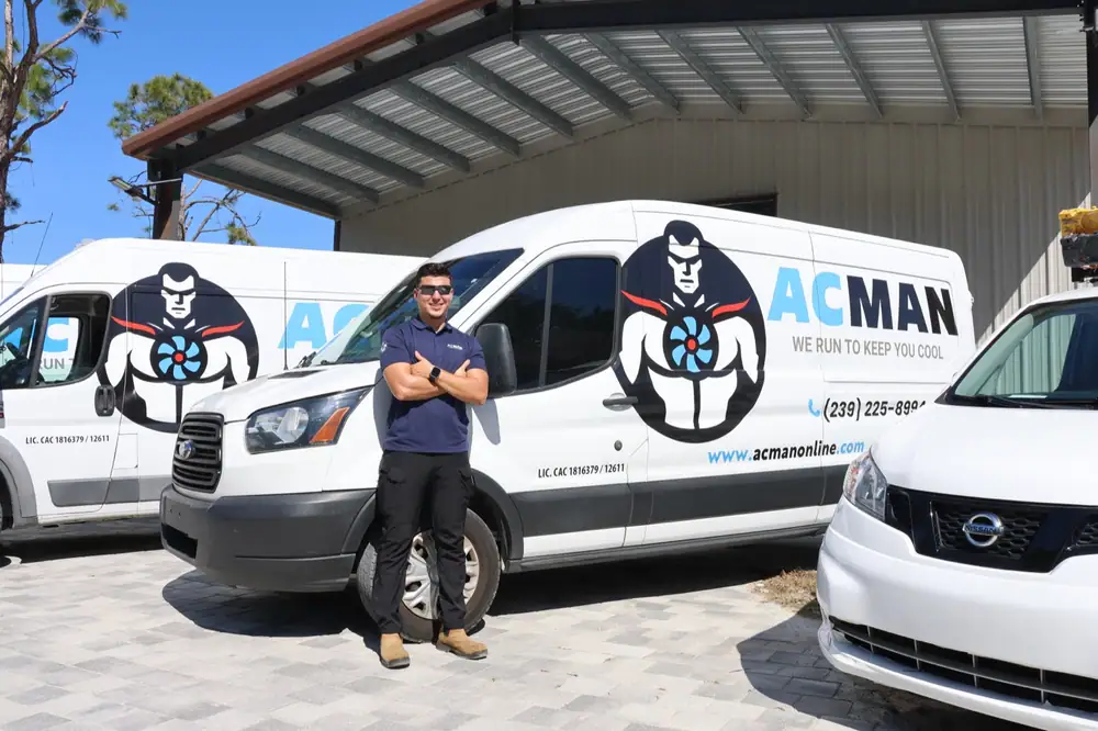 An ACMAN technician in front of the van fleet
