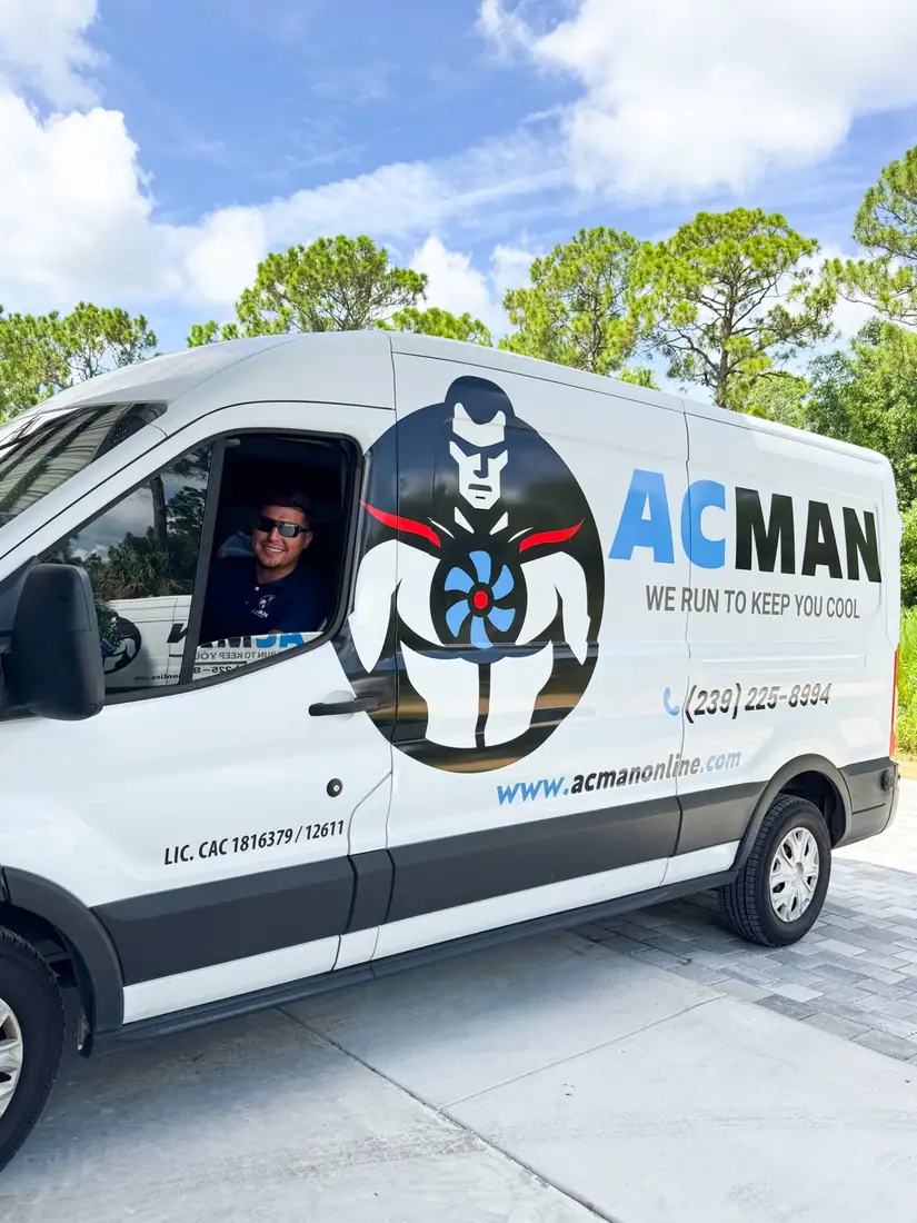 An ACMAN technician smiling from the van window
