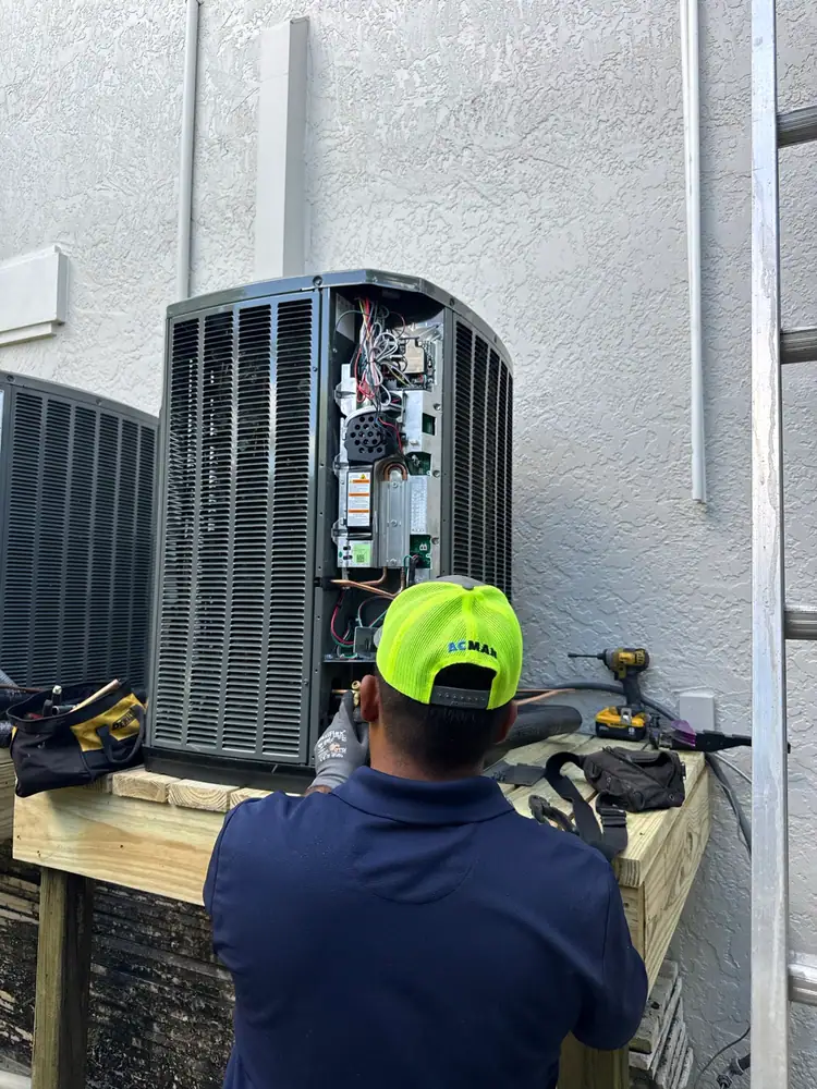 Two new condensers on a raised platform beside a home