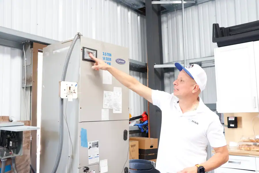 A trainer walking ACMAN technicians through an air handler