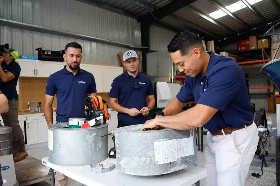 ACMAN technicians at a training bench